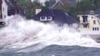 FILE - Waves slam along the shore near high tide as the remnants of Hurricane Ida leave Massachusetts, Sept. 2, 2021, in Scituate, Mass.