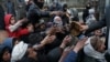 People reach out to receive bread in Kabul, Afghanistan, Jan. 31, 2022.