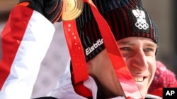 Matthias Mayer of Austria celebrates with his gold medal for the men's super-G, Feb. 8, 2022.