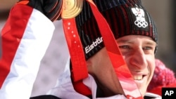 Matthias Mayer of Austria celebrates with his gold medal for the men's super-G, Feb. 8, 2022.