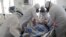 Medical staff members wearing special suits to protect against coronavirus treat a patient with coronavirus at an ICU of the Clinical hospital in Volgograd, Russia, Jan. 31, 2022. 
