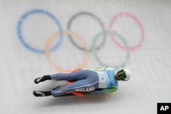 Elsa Desmond, of Ireland, slides during the luge women's singles run 1 at the 2022 Winter Olympics (AP Photo/Dmitri Lovetsky)