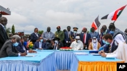 FILE - The then-head of Sudan's sovereign council, Gen. Abdel-Fattah Burhan, seated center-left, President of South Sudan Salva Kiir, seated center, and then-President of Chad Idriss Deby, seated center-right, attend a ceremony to sign a peace deal in South Sudan, Oct. 3, 2020.