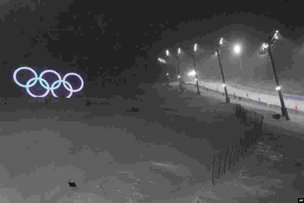 Olympic rings sit next to the moguls course, Jan. 30, 2022, in Zhangjiakou, China.