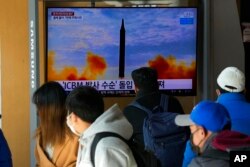 Orang-orang menonton TV yang menampilkan gambar peluncuran rudal Korea Utara saat program berita di Stasiun Kereta Api Seoul di Seoul, Korea Selatan, 30 Januari 2022. (Foto: AP)