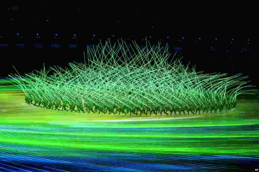 Dancers perform with light sticks during the opening ceremony of the 2022 Winter Olympics, Feb. 4, 2022, in Beijing. 