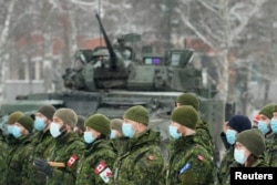 Canadian troops of NATO enhanced Forward Presence battle group attend a meeting with Canadian Defence Minister Anita Anand, in Adazi, Latvia, Feb. 3, 2022.