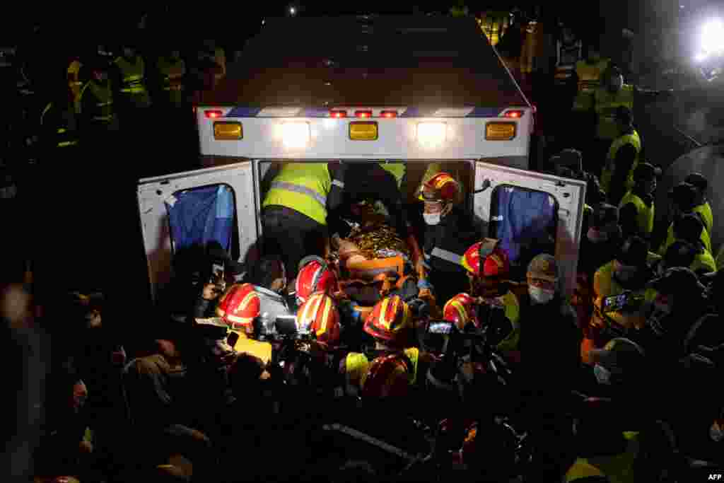 Moroccan emergency services teams carry five-year-old Rayan Oram into an ambulance after pulling him out from a well where he had fallen into on Feb. 1, in the remote village of Ighrane, in the rural northern province of Chefchaouen, Morocco, Feb. 5, 2022.