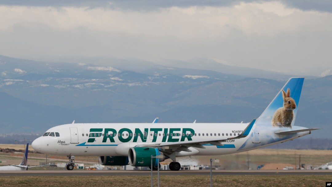 FILE - A Frontier Airlines jet taxis to a runway to take off from Denver International Airport, in Denver, Colorado, April 23, 2020. 