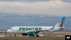 FILE - A Frontier Airlines jet taxis to a runway to take off from Denver International Airport, in Denver, Colorado, April 23, 2020. 