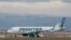 FILE - A Frontier Airlines jet taxis to a runway to take off from Denver International Airport, in Denver, Colorado, April 23, 2020. 
