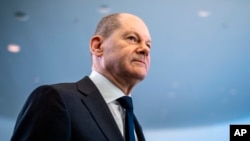 FILE - German Chancellor Olaf Scholz leaves after a news conference ahead of a one-day closed meeting of the German Cabinet at the Chancellery in Berlin, Germany, Jan. 21, 2022.