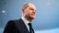 FILE - German Chancellor Olaf Scholz leaves after a news conference ahead of a one-day closed meeting of the German Cabinet at the Chancellery in Berlin, Germany, Jan. 21, 2022.