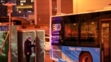 A security guard opens a gate to let in a bus inside the Olympic "closed-loop" in Beijing, China, Feb. 7, 2022.