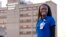 In this Feb. 1, 2022, photo provided by University of Louisville Hospital, Faith Akinmade, an ICU nurse from Nigeria, poses for a photo in front of the hospital.
