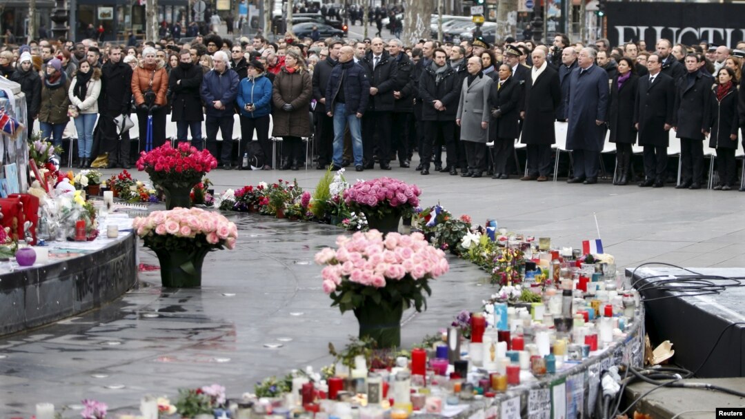 People attend a ceremony at Place de la Republique to pay tribute to the victims of last year's shooting at the French satirical newspaper Charlie Hebdo, in Paris, Jan. 10, 2016.