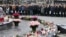 People attend a ceremony at Place de la Republique to pay tribute to the victims of last year's shooting at the French satirical newspaper Charlie Hebdo, in Paris, Jan. 10, 2016.