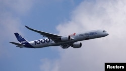 FILE - An Airbus A350-1000 flies during an aerial flying display ahead of the Singapore Airshow at Changi Exhibition Centre in Singapore, Feb. 18, 2024. 