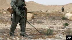 Russian serviceman checks for mines in Palmyra, Syria, in this photo provided by Russian Defense Ministry press service, April 8, 2016.