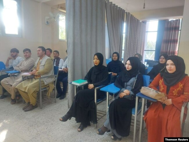 FILE - Students attend class under new gender separation rules, at Avicenna University in Kabul, Afghanistan Sept. 6, 2021, in this picture obtained by Reuters from social media.