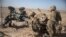FILE - U.S. soldiers ready a howitzer to be towed into position at Bost Airfield in Afghanistan's Helmand Province in this June 10, 2017 photo provided by Operation Resolute Support. The U.S. and NATO deny Iranian allegations that U.S. troops in Afghanistan support Islamic State militants.