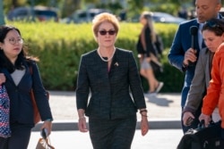 FILE - Former U.S. ambassador to Ukraine Marie Yovanovitch, center, arrives to testify on Capitol Hill, in Washington, Oct. 11, 2019.