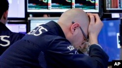 Specialist Mario Picone works at his post on the floor of the New York Stock Exchange, April 6, 2018. Stocks fell again as trade tensions grew between the U.S. and China.