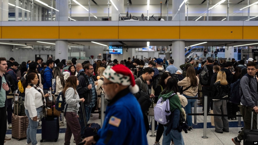 Travelers wait in line for security checks at the Los Angeles International Airport in Los Angeles, Dec. 24, 2024.