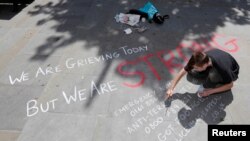 Mladić piše poruku na betonu u centru Manchestera