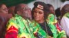 FILE - Zimbabwean President Robert Mugabe and his wife, Grace, follow proceedings during a youth rally in Marondera, about 100 kilometers east of Harare, June, 2, 2017. 