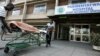 FILE: A patient is taken home on a stretcher by his relatives from Parirenyatwa hospital's accident and emergency ward in the capital Harare August 21, 2009. 
