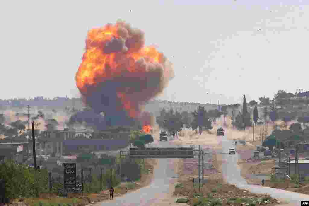 A fireball erupts from the site of an explosion reportedly targeting a joint Turkish-Russian patrol on the strategic M4 highway, near the Syrian town of Ariha in the rebel-held northwestern Idlib province.