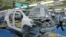 A worker walks past a Toyota Motor Yaris sedan at Central Motor Co's new factory in Ohira village, Japan, April 16, 2011