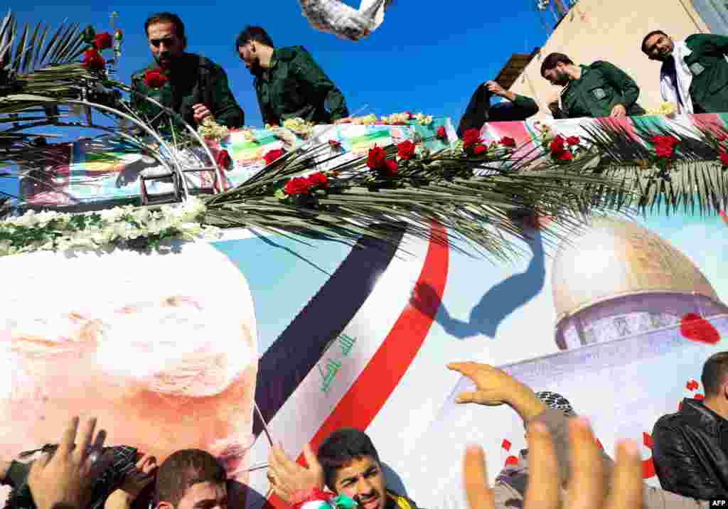 The coffins of slain top commander Qasem Soleimani and Iraqi paramilitary chief Abu Mahdi al-Muhandis, are transported atop a vehicle upon their arrival at Ahvaz International Airport in southwestern Iran. A tide of mourners packed the streets of the city of Ahvazto pay respects to top general Soleimani, days after he was killed in a U.S. strike.