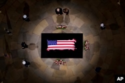 President-elect Donald Trump and Melania Trump pause at the flag-draped casket of former President Jimmy Carter as he lies in state in the rotunda of the US Capitol in Washington, Jan. 8, 2025.