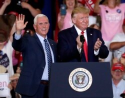 FILE - Vice President Mike Pence and President Donald Trump greet the crowd at a rally in Fayetteville, N.C., Sept. 9, 2019.