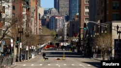 An investigator walks across Boylston Street near the site of the bombings in Boston, April 21, 2013.