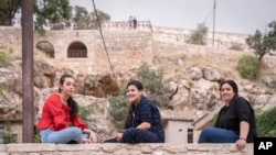 Visitors sit together in Lalish, the Yazidi's most holy temple, in the Shekhan district of the Kurdistan region of Iraq, June 24, 2024.