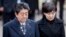 FILE - Japanese Prime Minister Shinzo Abe, left, and his wife Akie Abe take part in a wreath laying ceremony at the Antakalnis Memorial Cemetery in Vilnius, Lithuania, Jan. 14, 2018.