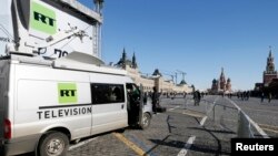 Vehicles of Russian state-controlled broadcaster Russia Today (RT) are seen at Red Square in central Moscow, Russia, March 18, 2018. 