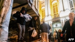 People unload bags of ballots from a truck at the Timis county Electoral Bureau in Timisoara, Romania, on Nov. 29, 2024. 