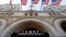 FILE - Flags fly above the entrance to the new Trump International Hotel on its opening day in Washington, D.C., Sept. 12, 2016. 