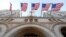 FILE - Flags fly above the entrance to the Trump International Hotel, in Washington, Sept. 12, 2016. 