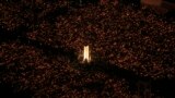 Tens of thousands of people attend a candlelight vigil at Victoria Park in Hong Kong to mark the 25th anniversary of the crackdown in China&#39;s Tiananmen Square.