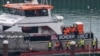 FILE - People believed to be migrants disembark from a British Border Force vessel as they arrive at the Port of Dover, in Dover, Britain, Dec. 29, 2024. 