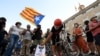 Anti-monarchy demonstrators burn pictures of the Spanish king during a protest against the visit of King Felipe VI of Spain to Catalonia, in Barcelona, June 15, 2021.