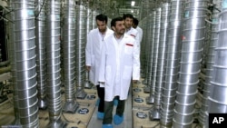 FILE - Iranian President Mahmoud Ahmadinejad, center, visits Natanz Uranium Enrichment Facility, some 200 miles (322 kilometers) south of Tehran, April 8, 2008.
