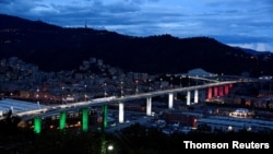 The new bridge in Genoa, Italy, is illuminated in the colors of the Italian flag during its official inauguration, August 3, 2020, after it was rebuilt following its collapse August 14, 2018, which killed 43 people. 