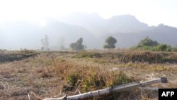 FILE - A Feb. 21, 2019, photo shows an unexploded mortar lying on a field in Rathedaung township after fighting in Rakhine state between Myanmar's military and the Arakan Army, an ethnic Rakhine force. 