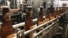 FILE - Bottles freshly filled with beer move on a conveyor belt at Lakefront Brewery in Milwaukee, Jan. 14, 2019.